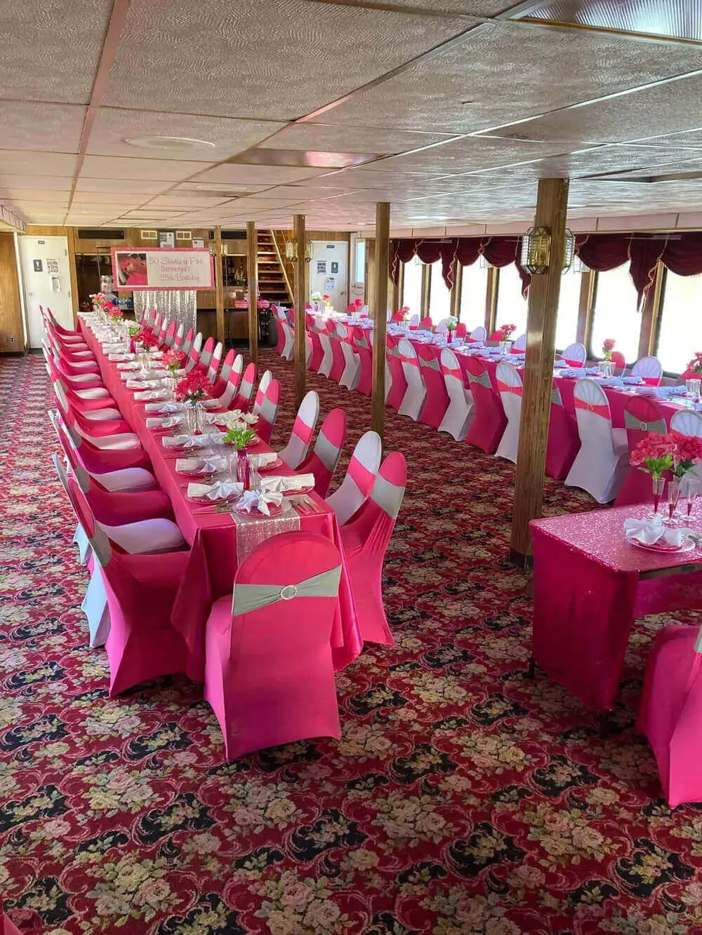 A dining deck dressed with chair covers, sashes, and centerpieces for a formal celebration
