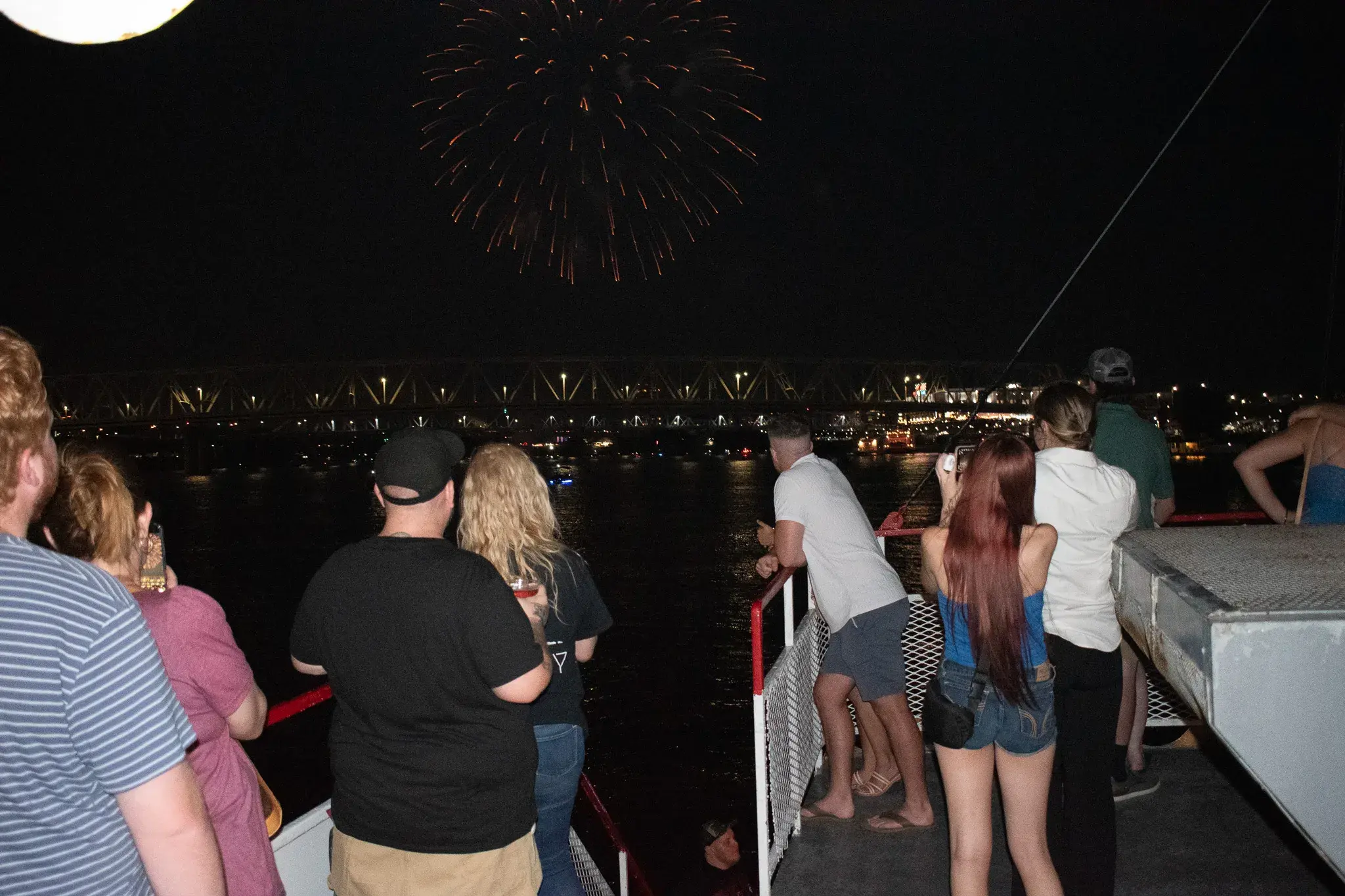 Guests watching fireworks over the Ohio River from the deck