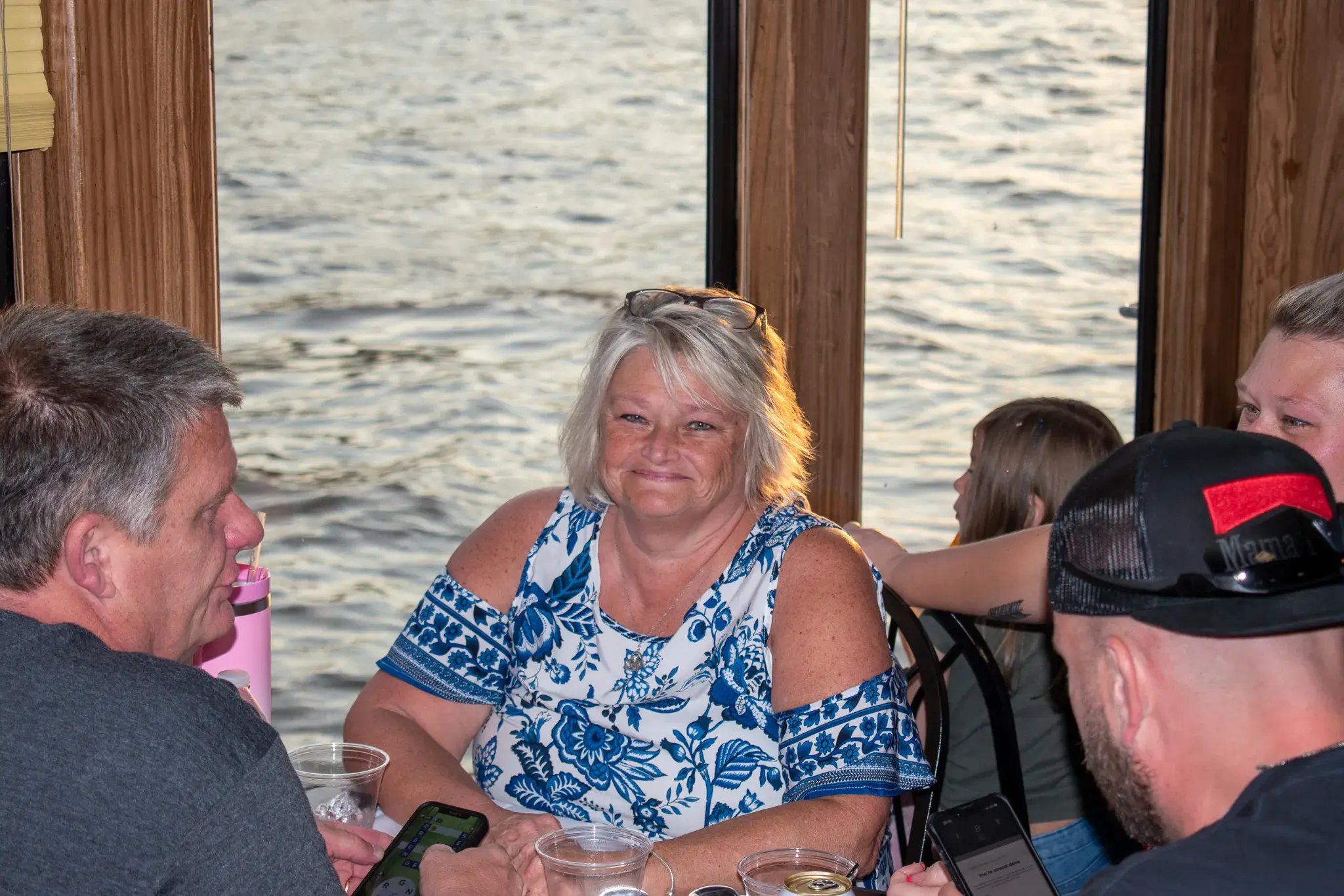 Guests dining at a window table as the Ohio River passes outside